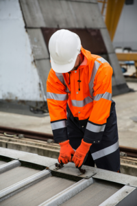 Engineer in FR boiler suit on site — the risks of washing PPE at home